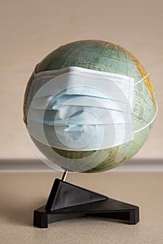 Earth globe with surgical mask