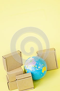 Earth globe is surrounded by boxes. Global business and international transportation of goods products. Shipping freight