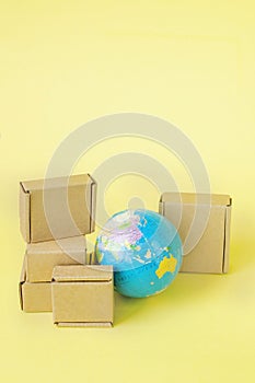 Earth globe is surrounded by boxes. Global business and international transportation of goods products. Shipping freight