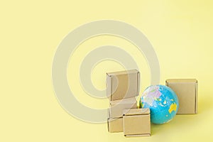 Earth globe is surrounded by boxes. Global business and international transportation of goods products. Shipping freight, world