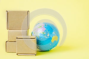 Earth globe is surrounded by boxes. Global business and international transportation of goods products. Shipping freight, world