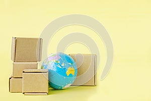 Earth globe is surrounded by boxes. Global business and international transportation of goods products. Shipping freight, world