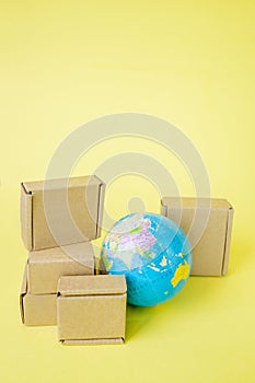 Earth globe is surrounded by boxes. Global business and international transportation of goods products. Shipping freight, world