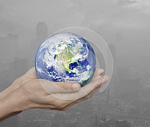 Earth in hands over pollution city, Environment concept, Element