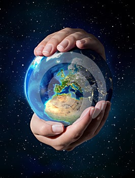 Earth in the hands - Universe background - Europe