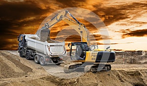 Earth mover and excavator at work