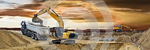 Earth mover and excavator at work in construction site