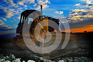 Earth mover machine at sunrise