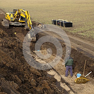 Earth mover and workman photo