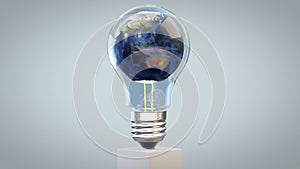 Earth planet revolving inside of a classic lightbulb, loop