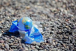 The Earth in a plastic bag. World Environment Day concept.