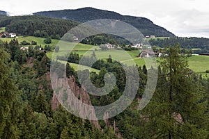 Earth pyramids in front of a scenic landscape of South Tyrol, Northern Italy