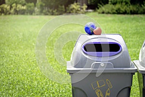 Earth with red heart on the recycle bin in the park, save the world, love and protect our planet, and environmental  friendly