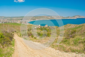 Earth road leading from Kara-dag natural reserve to settlement Kotebel on a Black Sea shore