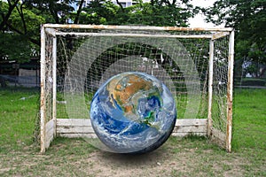 The earth on soccer goal, including elements furnished by NASA.