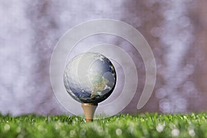 Earth Sticking with the golf ball on a tee peg.