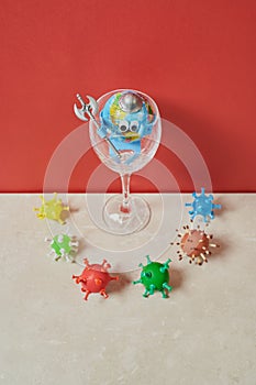 Earth toy in a cup with an ax surrounded by viruses