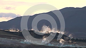 Earth, volcanic activity, Geothermal area , fumaroles volcanic boiling mud pots, Iceland. Smoke on the ground. Global