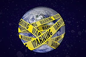 Earth with warning yellow tape. Global catastrophe concept.