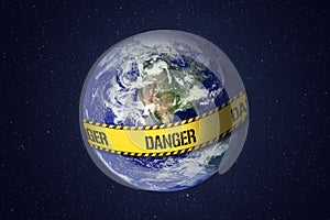 Earth with warning yellow tape. Global catastrophe concept.