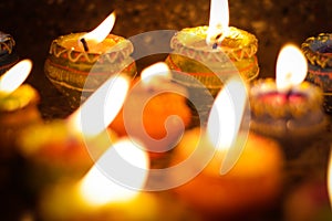 Earthen diya lamp lighting with candles on the occasion of diwali and sandhi pujo