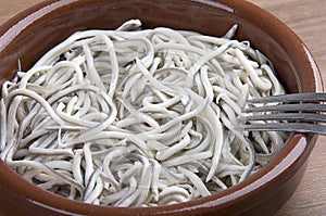 Earthenware bowl withyoung eels cooked with garlic