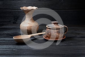 Earthenware pottery on black wooden background