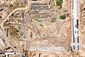 Earthmoving and asphalt pavement works at road construction site. aerial view