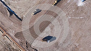 Earthmoving equipment. Aerial view of a large construction site with several earthmoving machines.