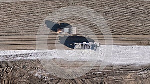 Earthmoving equipment. Aerial view of a large construction site with several earthmoving machines.