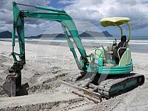Earthmoving equipment: excavator on beach