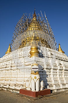 After an earthquake, the damaged, golden stupa of a pagoda in Bagan