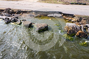 After an earthquake and strong storm in winter and severe destructive frost, asphalt road on landslide swept into sea. Closed road