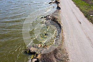 After an earthquake and strong storm in winter and severe destructive frost, asphalt road on landslide swept into sea. Closed road