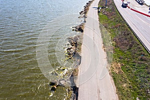 After an earthquake and strong storm in winter and severe destructive frost, asphalt road on landslide swept into sea. Closed road