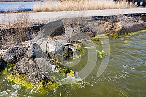 After an earthquake and strong storm in winter and severe destructive frost, asphalt road on landslide swept into sea. Closed road