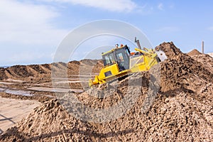 Earthworks Dozer Machine Pushing Sand photo