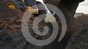 Earthworks in countryside. Modern bulldozer burying trench at construction site