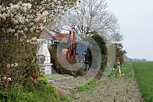 Earthworks in the garden with a backhoe. photo