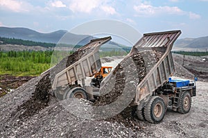 Earthworks in a mountainous forest area in the summer.