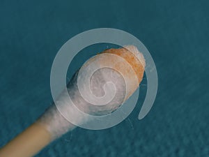 Earwax on a cotton swab, macro photo. Earwax, also known by the medical term cerumen, is a brown, orange, red, yellowish or gray