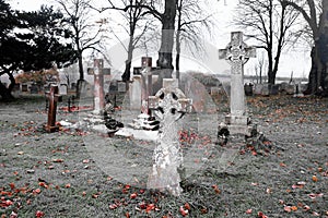 Scarey grave yard with crosses as head stones back and white photograph photo