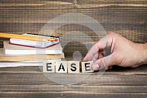 Ease. Wooden letters on the office desk