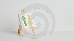 easel with an arrow symbol in front of it on a white surface