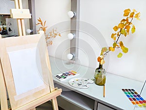 The easel in art studio on the background