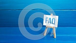 Easel with FAQ frequently asked questions. Available answers to overcome difficulties and misunderstandings. Guide, navigation.