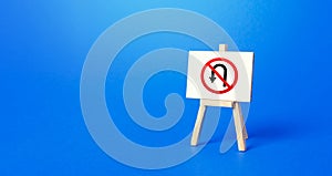 Easel with no turning back traffic sign. Turn arrow and red prohibition symbol photo