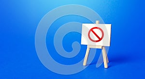 Easel with the prohibition sign NO on a blue background. Restricted area. Restrictions and Sanctions. Out of stock. Ban