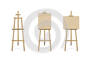 Easel standing with beige board or canvas set. Blank blackboard on wooden tripod for art, painting, drawing or