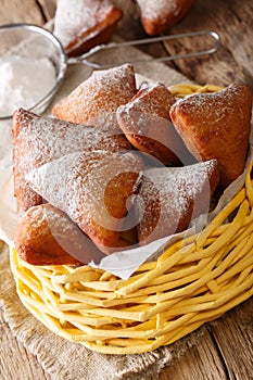 East African Mandazi dabo donuts with powdered sugar close up